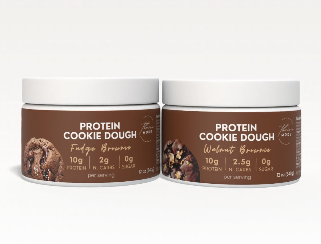 Two protein cookie dough containers on a white background