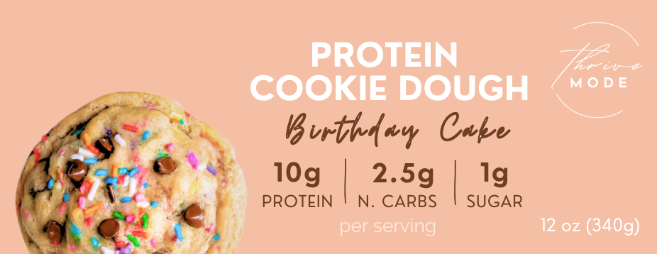 Protein cookie dough with birthday cake flavor on a beige background, featuring nutritional information.